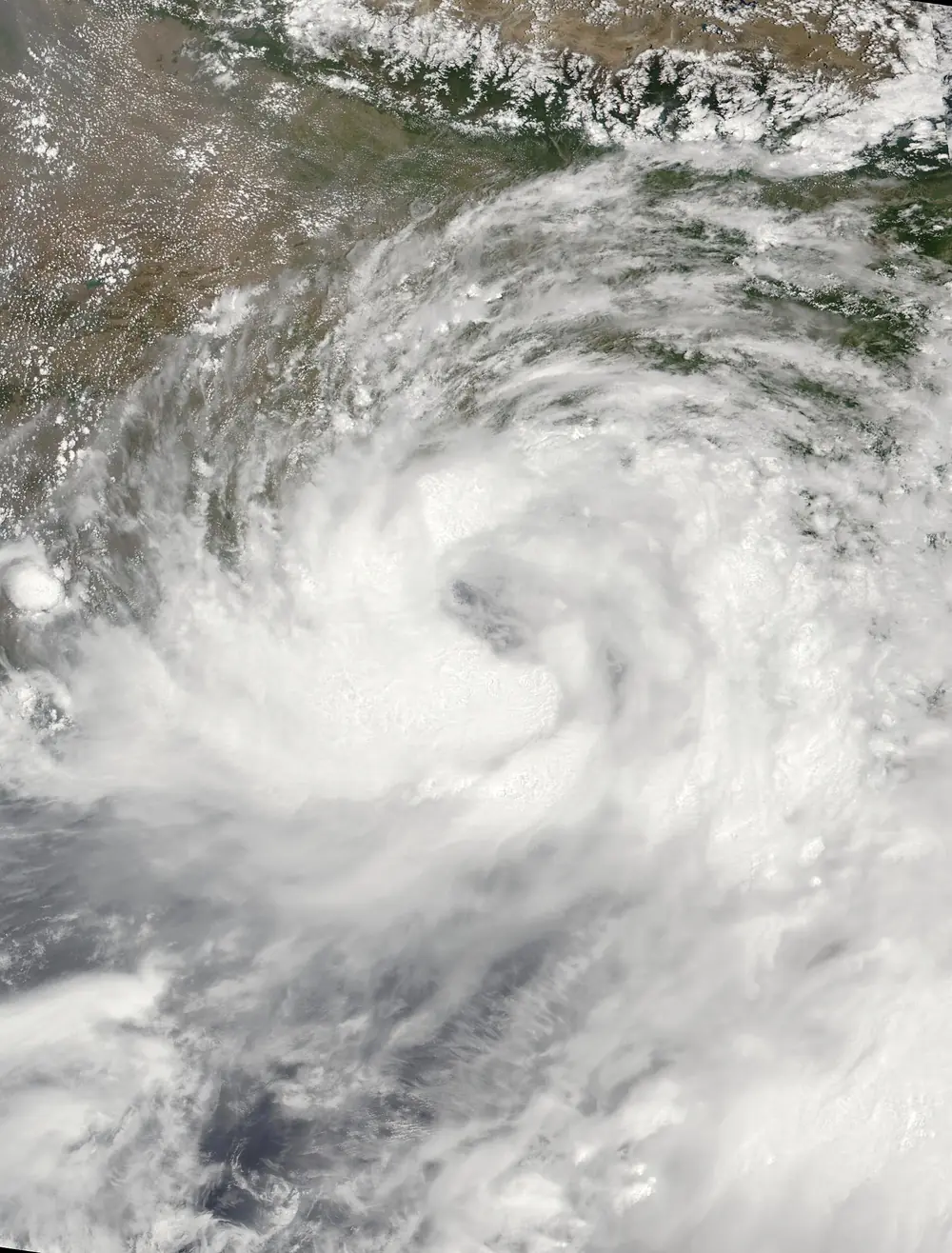 Satellite image of Cyclone Remal over the head of the Bay of Bengal near the Bangladesh and West Bengal coasts